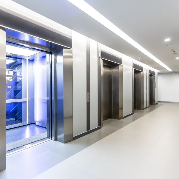 Modern steel elevator doors opened cabins in a business lobby or Hotel, Store, interior, office,perspective wide angle. Four elevators in hotel lobby.